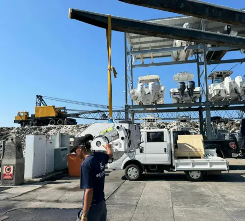 Seakeeper stabilizer being lifted by a hoist during installation aboard a boat.
